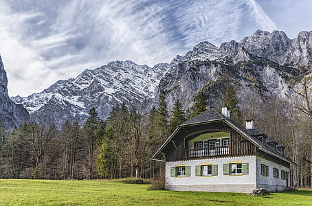 gray and brown house near mountains during daytime thumbnail
