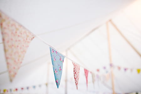 assorted-color pennants decors under white textile thumbnail