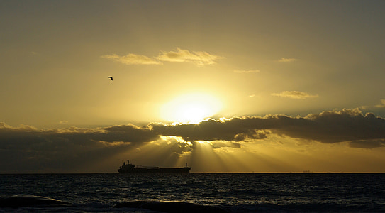 silhouette of ship floating on body of water thumbnail