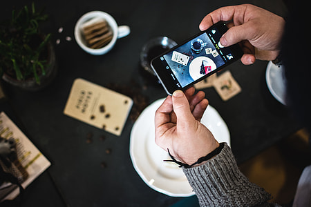 Man shooting cake with his iPhone thumbnail