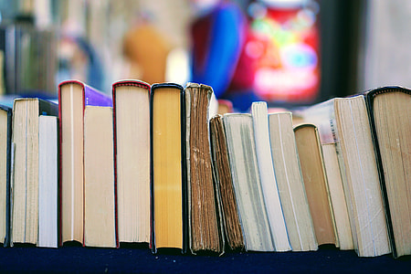 piled book on black shelf thumbnail