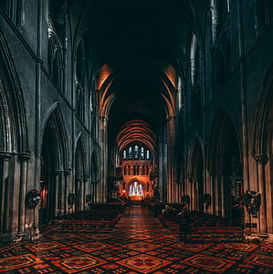 large gray concrete cathedral with orange and black tiled flooring thumbnail