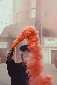 man holding a smoke grenade thumbnail