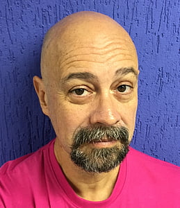 man in pink shirt taking selfie thumbnail