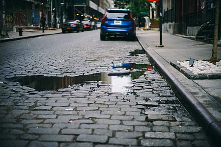water on road near parked vehicles thumbnail