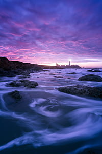 photography of body of water near lighthouse thumbnail