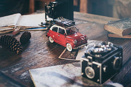 red and white 3-door hatchback scale model on brown wooden desk thumbnail