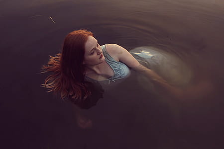 woman swimming on body of water thumbnail