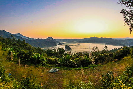 Body of Water Near Mountain at Daytime thumbnail