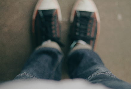person wearing pair of black-and-white low top sneakers thumbnail