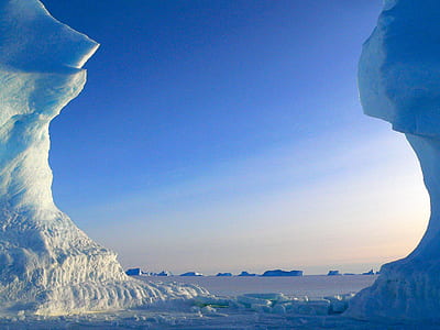 ice on body of water under blue sky thumbnail