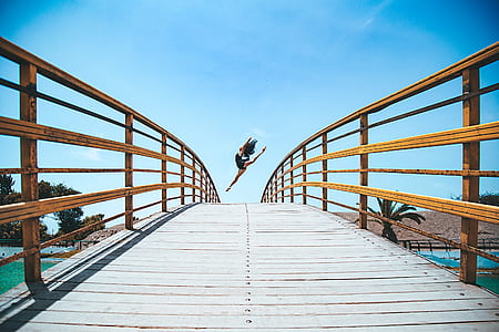 photo of woman leaping on bridge thumbnail