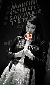 grayscale photography of woman holding candy thumbnail