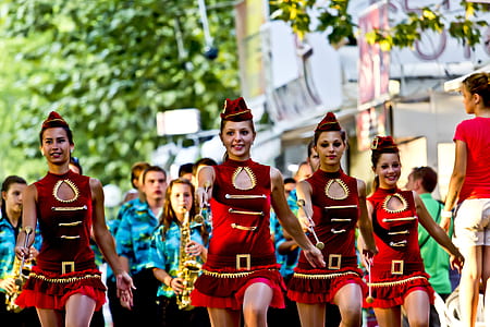 selective focus photography of women and men marching on road thumbnail
