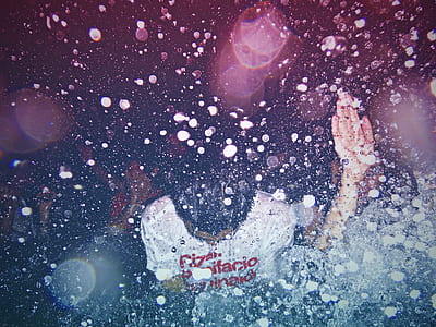 man wearing white shirt with water droplets photo thumbnail