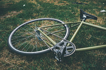 close-up photography of green bike on green grass field thumbnail
