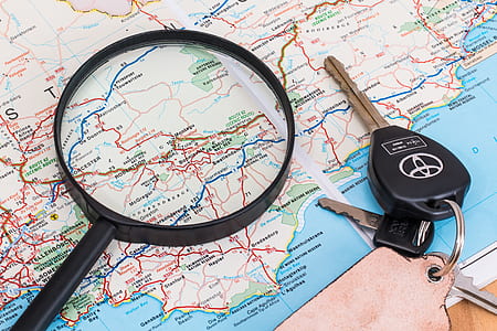 black magnifying glass beside black Toyota key on map thumbnail