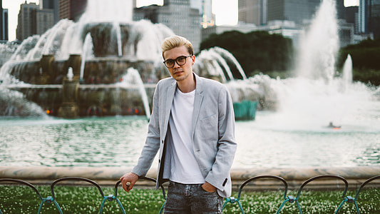 man standing near water fountain thumbnail
