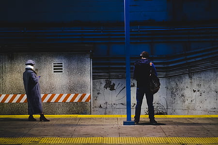 two people standing in subway station thumbnail