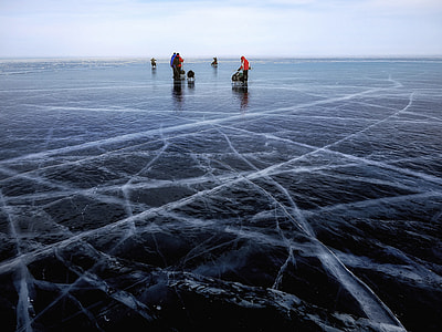 group of person standing on frozen body of water thumbnail