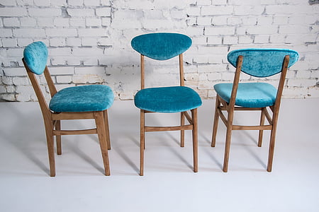 blue fabric chairs with brown wooden frame near white wall thumbnail