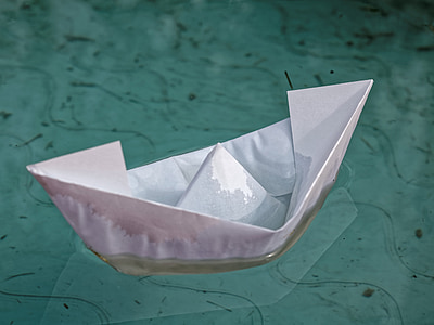 white boat paper on body of water thumbnail