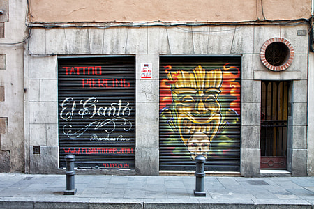 Tattoo and piercing shop with street art in Barcelona, Spain thumbnail