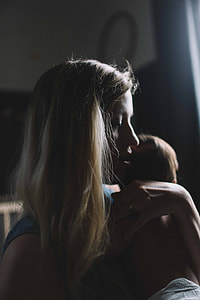 woman carrying baby thumbnail