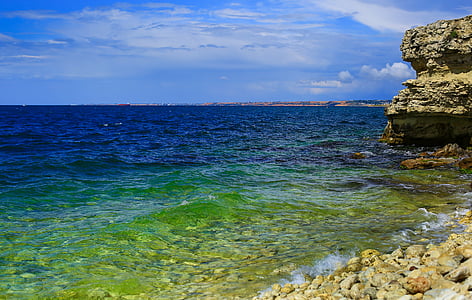 ocean under cloudy sky thumbnail