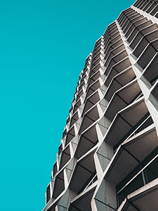 low-angle photography of white concrete building thumbnail