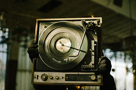 person holding black and gray Sony vinyl player thumbnail