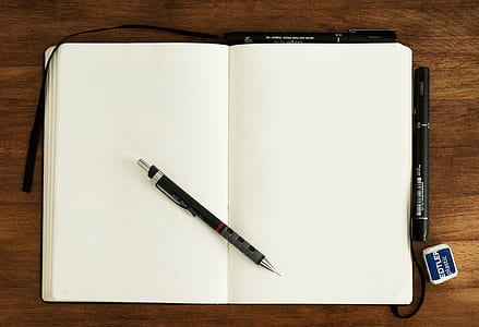 black and gray click pen on notebook thumbnail
