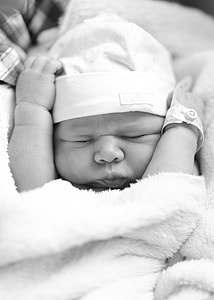 grayscale photo of newborn baby closing her eyes thumbnail