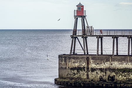 watchtower beside wide body of water thumbnail