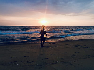 Silhouette of Man Playing Ball in Seashore thumbnail