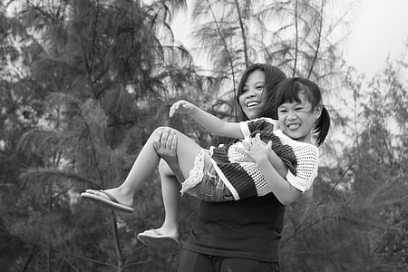 woman carrying a girl near on forest trees thumbnail
