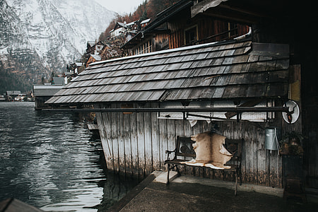 gray wooden house near body of water thumbnail