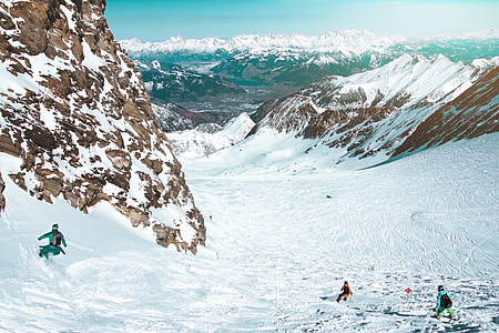 three person near mountain coated snow thumbnail