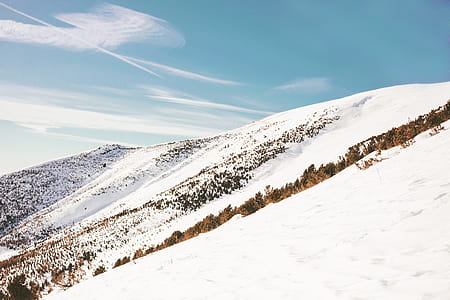mountain peak under blue sky during day time thumbnail