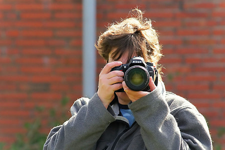 person holding DSLR camera thumbnail