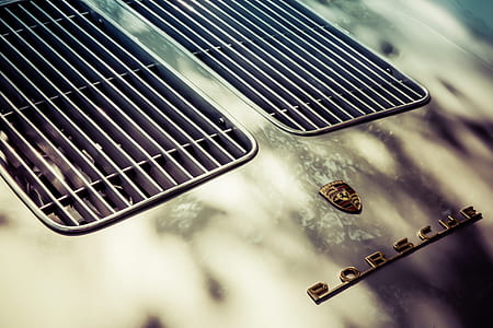 gray Porsche hood in close-up photo thumbnail