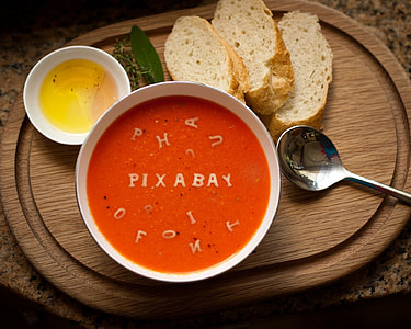 sliced bread on brown wooden tray and broth on white ceramic bowl thumbnail