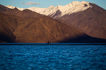 landscape photography of mountains beside body of water thumbnail