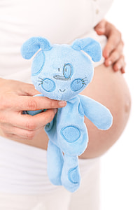 pregnant woman holding blue plush toy thumbnail