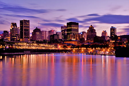 panoramic photography of high rise buildings at night thumbnail