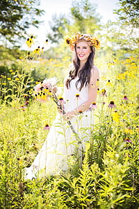 woman holding flowers during daytime thumbnail