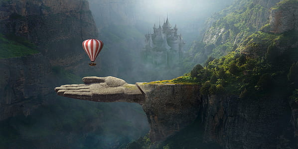 red and white striped hot air balloon above gray human hand mountain thumbnail