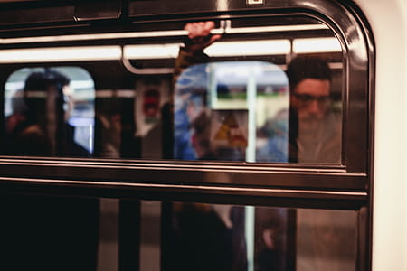 Man Standing Inside Train Waiting to Stop thumbnail