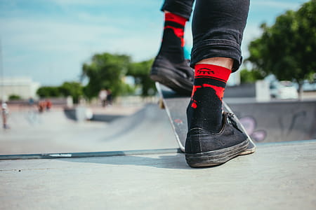 A skateboarder wearing black jeans and sneakers getting ready for halfpipe thumbnail