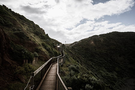 landscape photography of empty bridge on mountains thumbnail